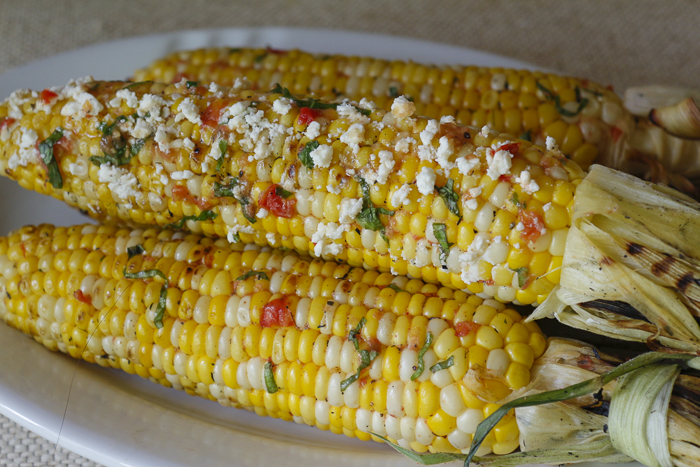 Add crumbled feta to finished grilled corn if desired