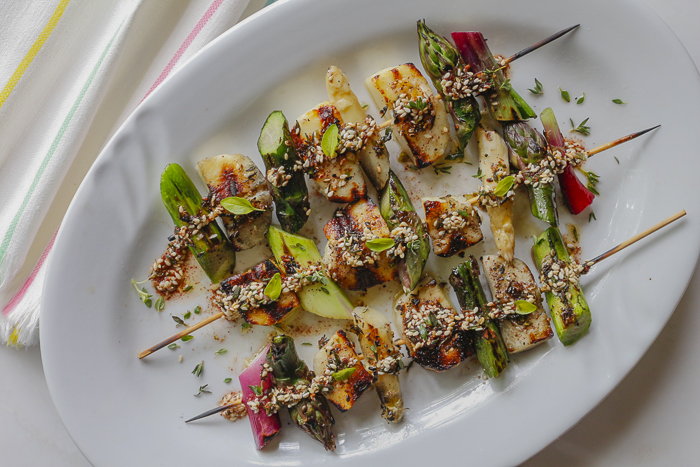 Spread Za'atar seasoning over luscious grilled skewers of Halloumi Cheese, Fresh Spring Asparagus and Scallions