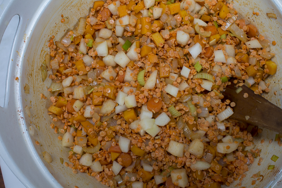 After the vegetables sauté, the red lentils and pears are added to the pot