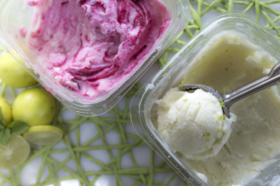 Pints of frozen yogurt, one with a blackberry swirl.