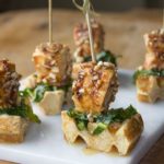 Pecan Chicken and Waffle Appetizer with Sautéed Collards and Maple-Bourbon Drizzle