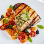 Pesto Compound Butter over Grilled Swordfish with Slow-Roasted Heirloom Tomatoes & Peppers