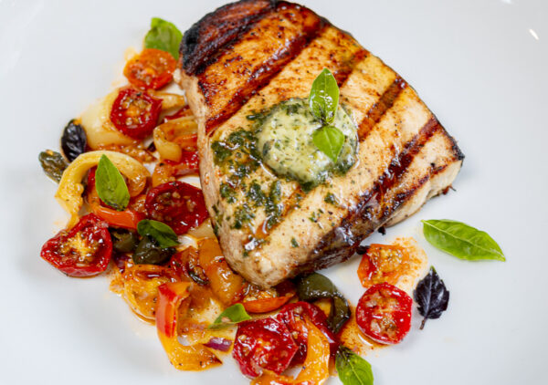 Pesto Compound Butter over Grilled Swordfish with Slow-Roasted Heirloom Tomatoes & Peppers