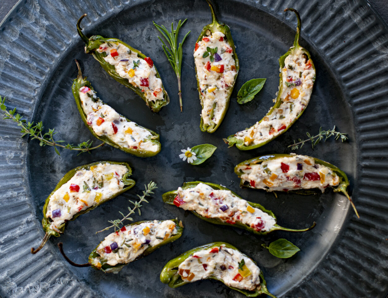 Stuffed with softened goat cheese, colorful peppers. tomatoes and herbs, then broiled one minute