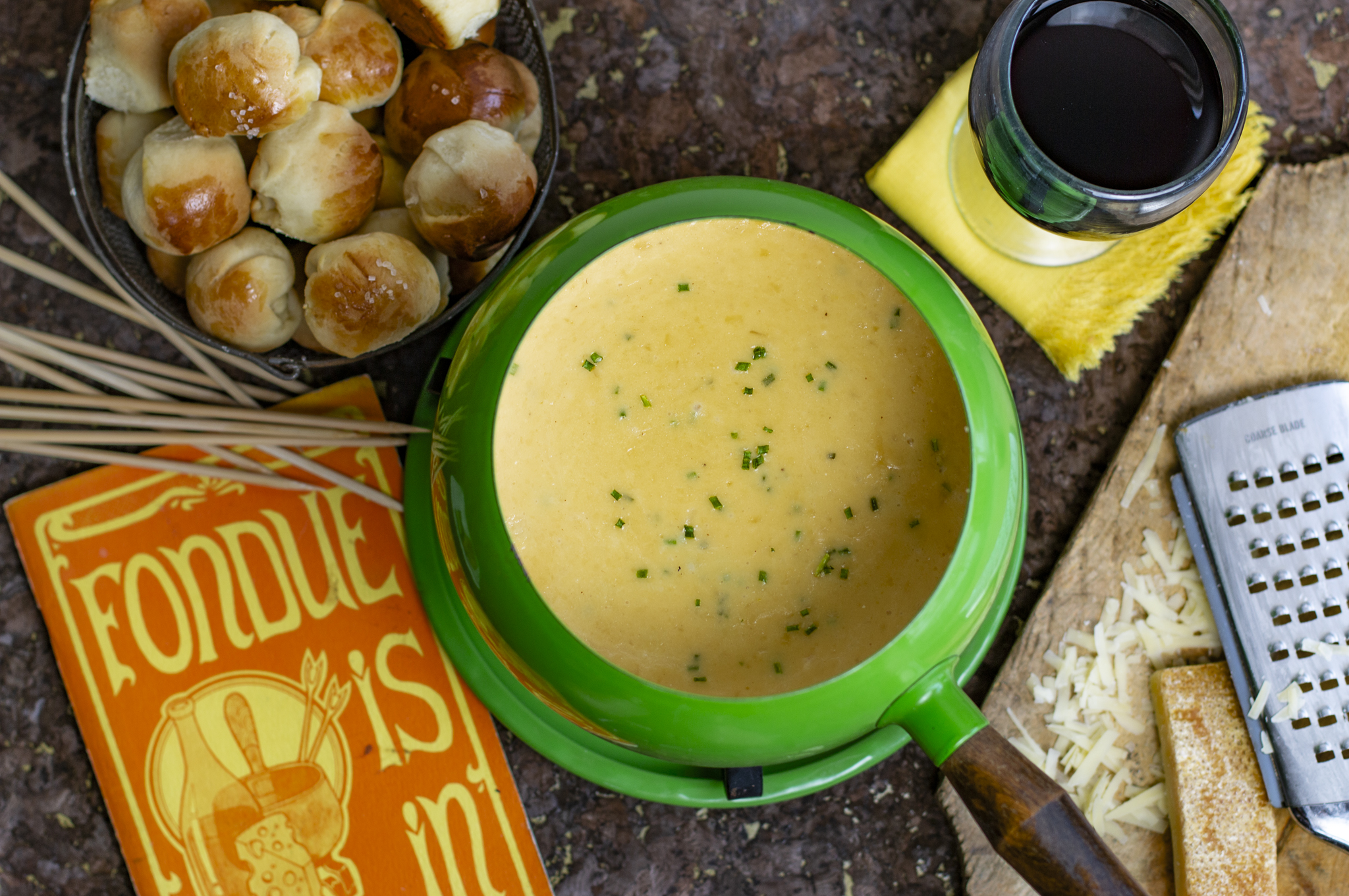 Swiss fondue done right with the addition of garlic and chives. Serve with my amazing Mini Dinner Rolls with Flaky Salt!