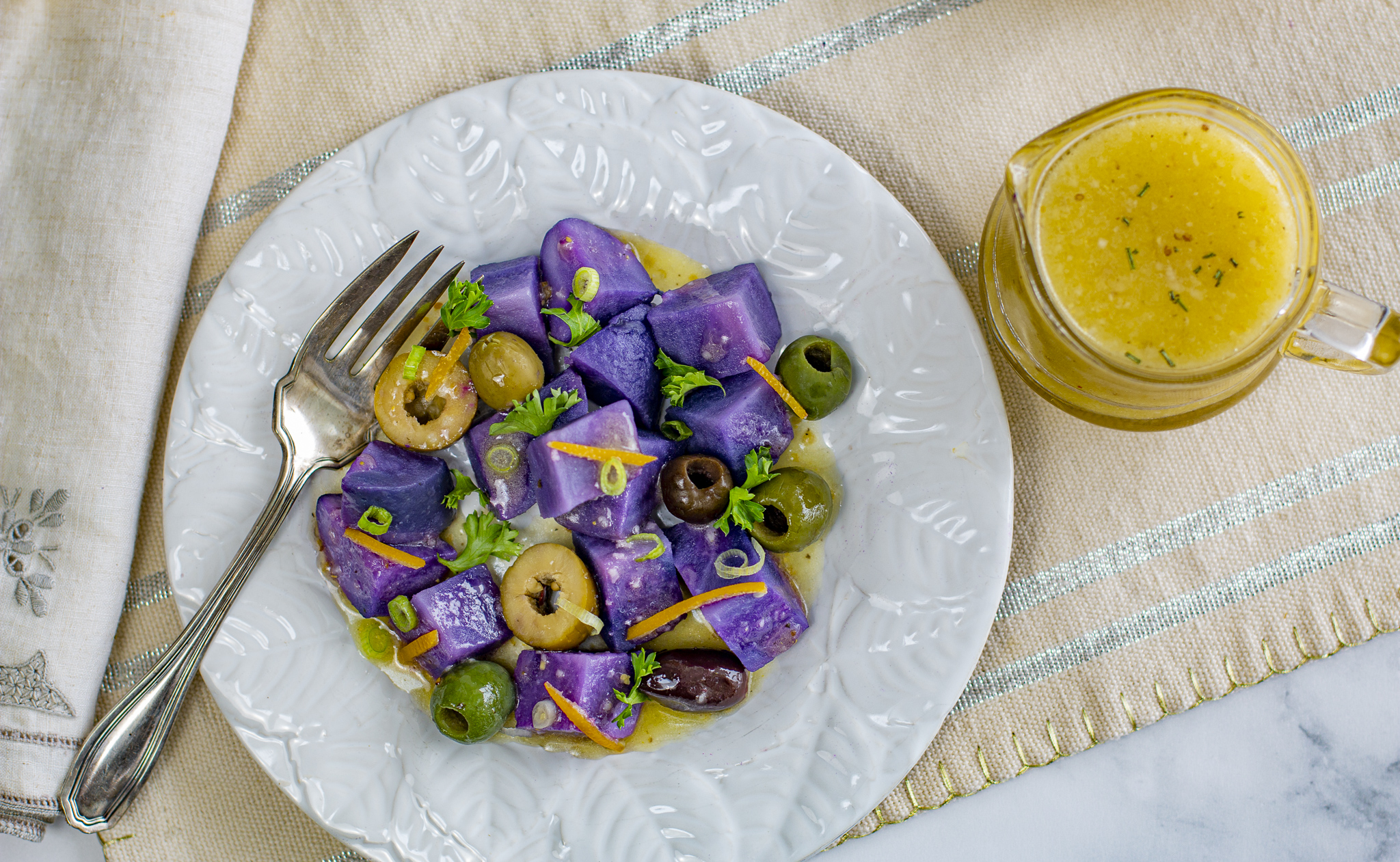 Purple Peruvian Potato salad with preserved lemon vinaigrette on vintage plates 
