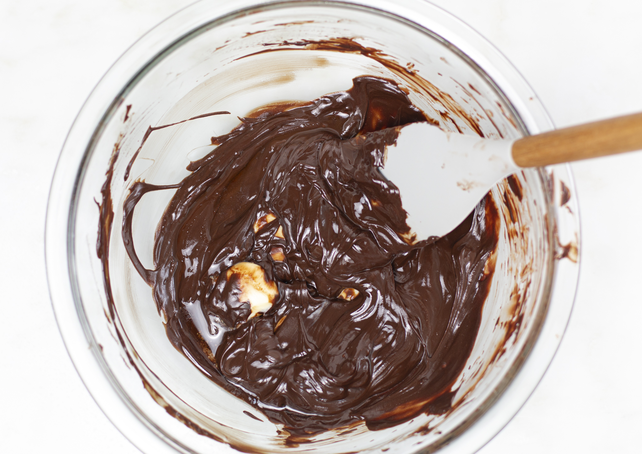 Melting chocolate and butter over a water bath with rubber spatula