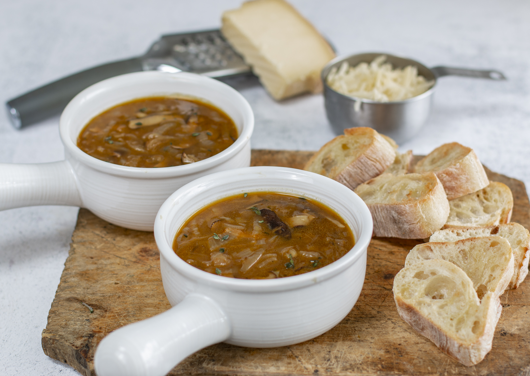 Ovenproof white modern crocks with rich onion soup 