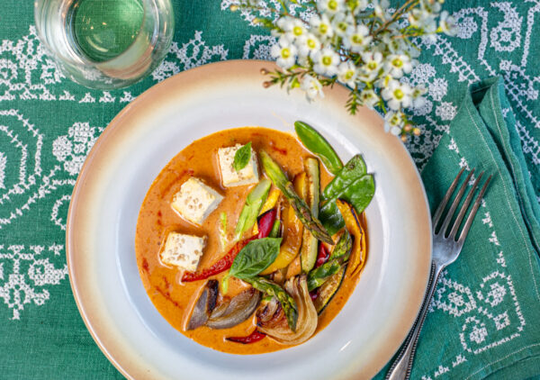 Red Coconut Curry with Sesame Tofu and Roasted Vegetables in vintage bowl with vintage aqua linens
