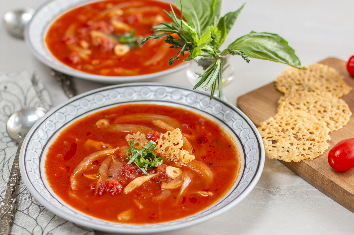Herbed Tomato and Fennel Soup with Parmesan Crisps in mid-century bowls