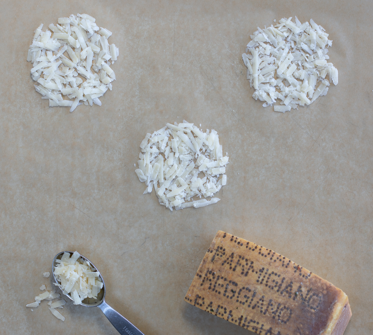 making Parmesan Crisps - adding cheese to parchment paper in little rounds