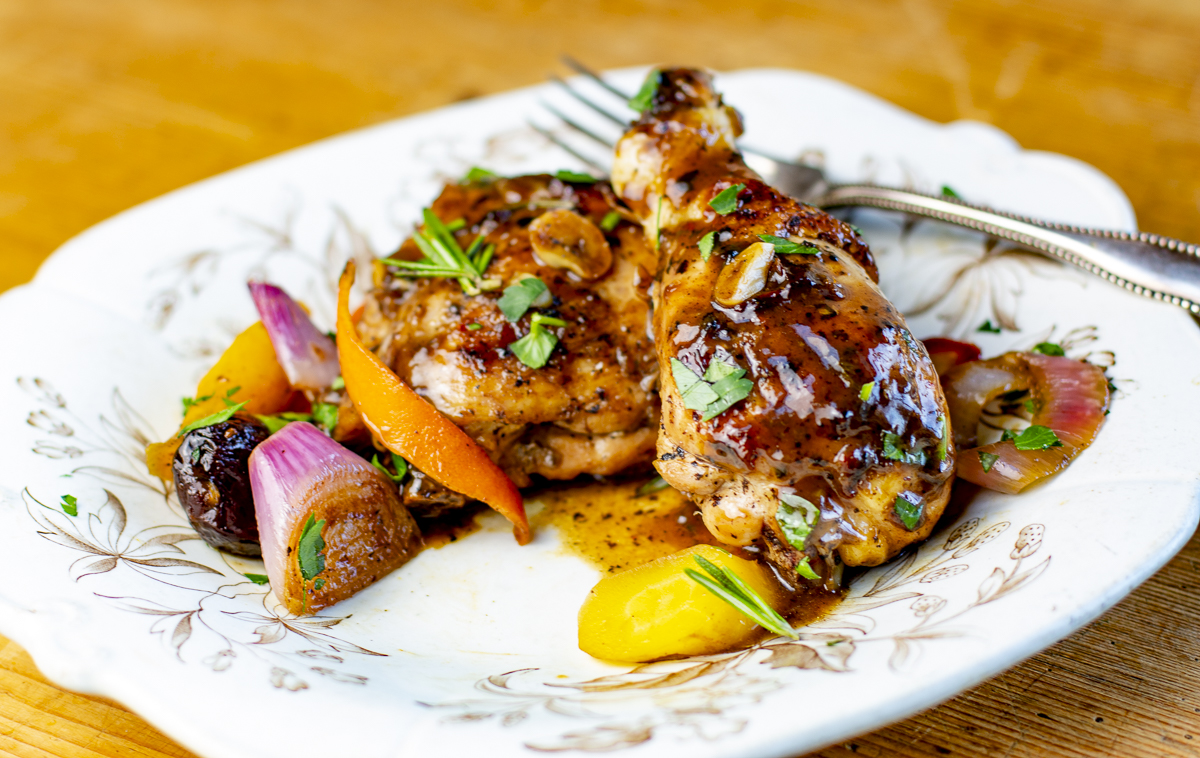 Braised Tzimmes Chicken with Balsamic-Rosemary Sauce for Passover on a vintage plate 