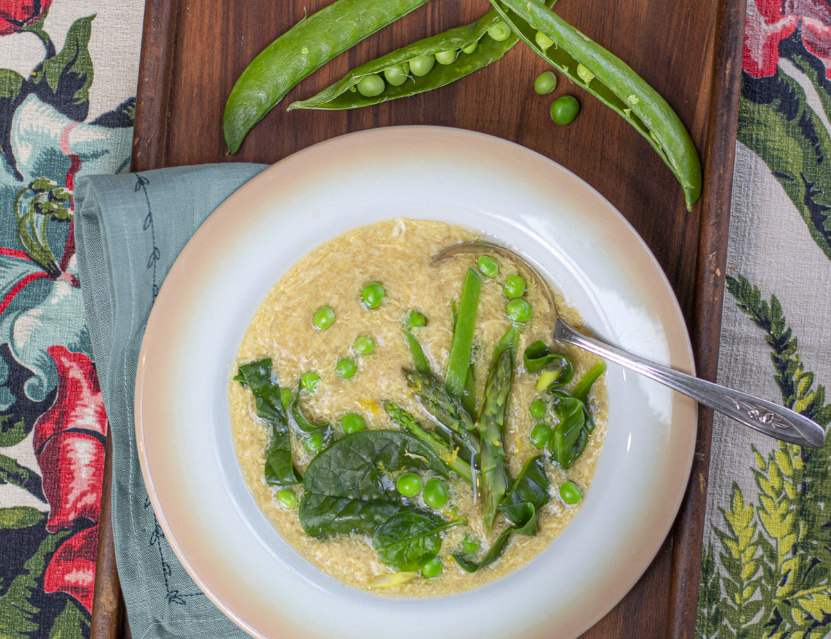 Spring egg drop soup with many green vegetables in a vintage bowl 
