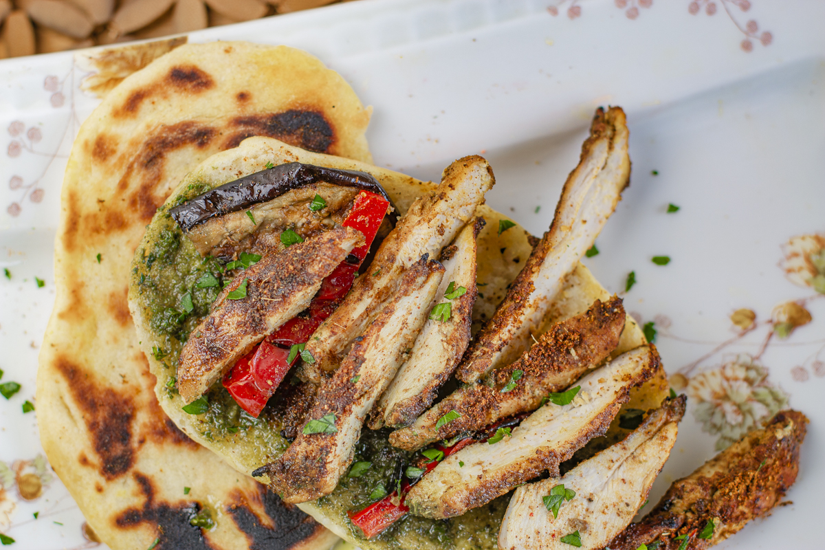 Sliced Iraqi Chicken on Homemade Naan Bread with Iraqi Pesto 