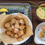 Homemade Panko Popcorn Spiced Shrimp in parchment lined white bowl
