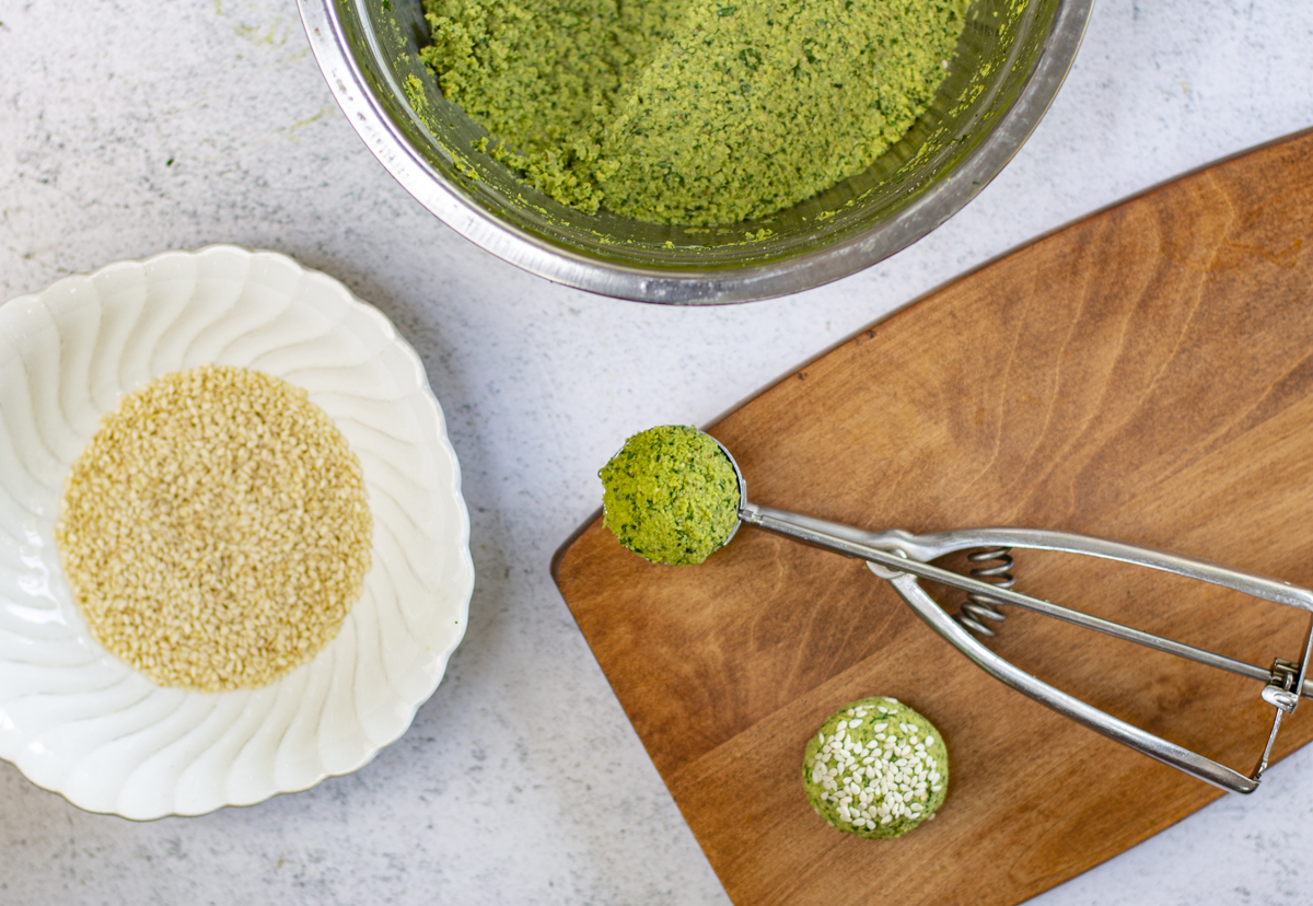 Scoop falafel - easiest with a 1 1/2 inch cookie scoop, then press each side into sesame seeds 