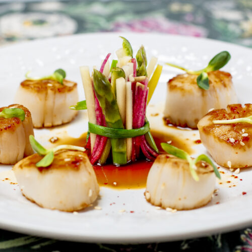 Seared Scallops with Karen's Ponzu Sauce on white embossed plate