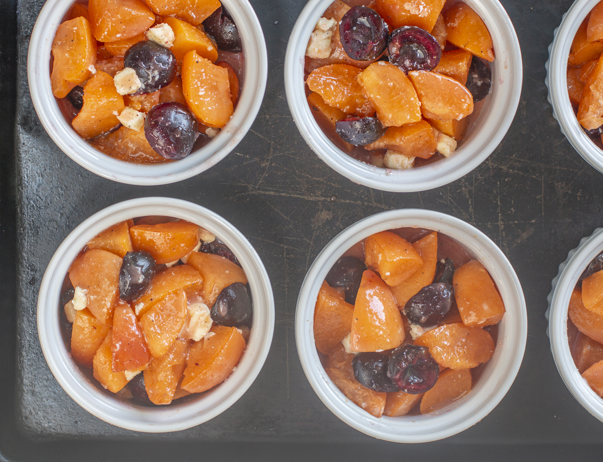 Portioning the fruit into six ramekins: Apricot-Cherry Cobblers 