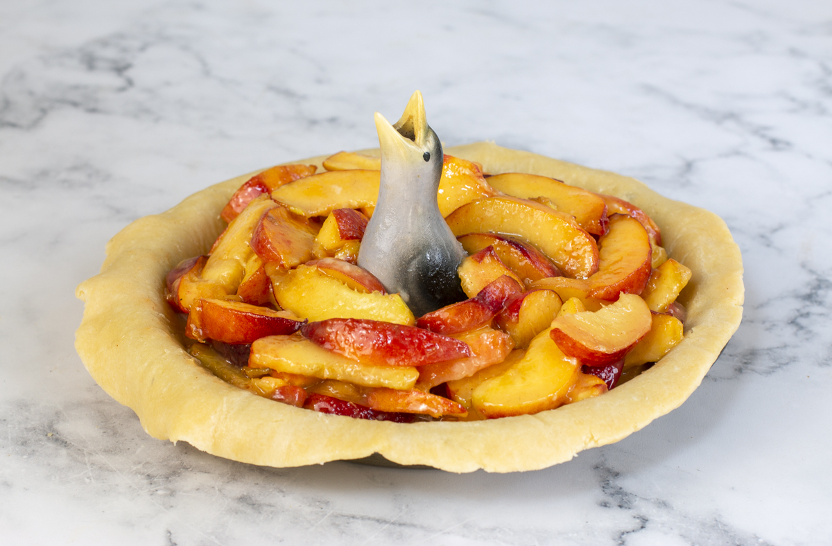 Peach pie with pie bird