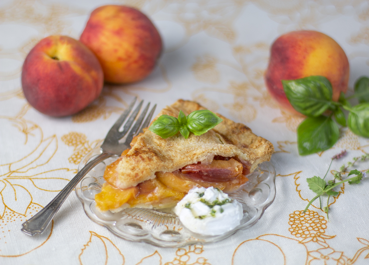 One piece of Peach Pie with whipped coconut cream with basil syrup 