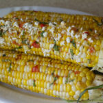 Grilled Corn in the Husk with Tomato-Basil Butter