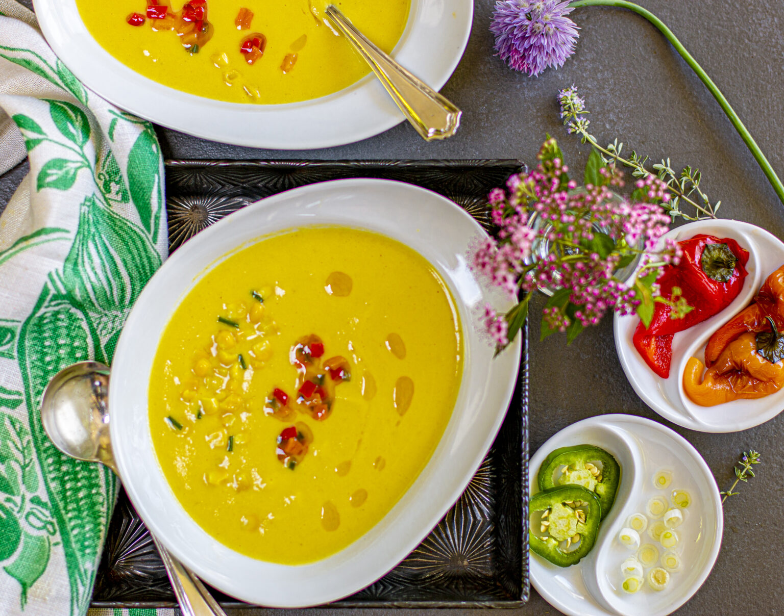 Velvety Cool Corn Soup in white oval bowl with toppings