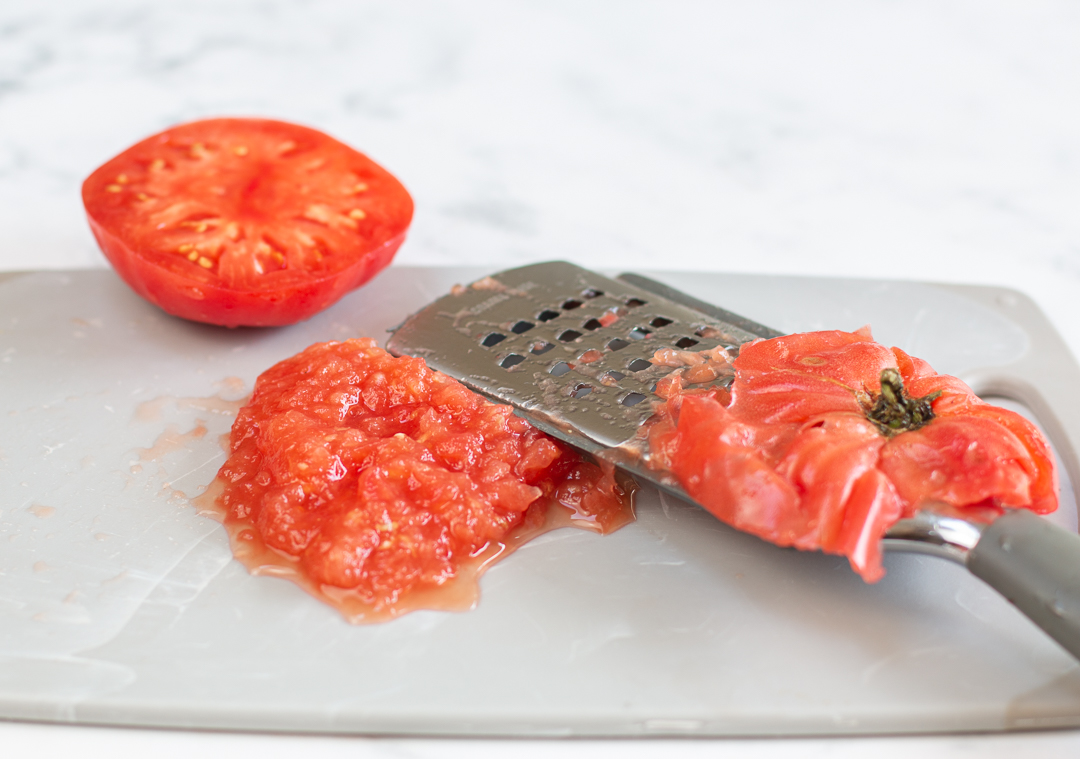 Grating tomatoes for Tomato Vinaigrette