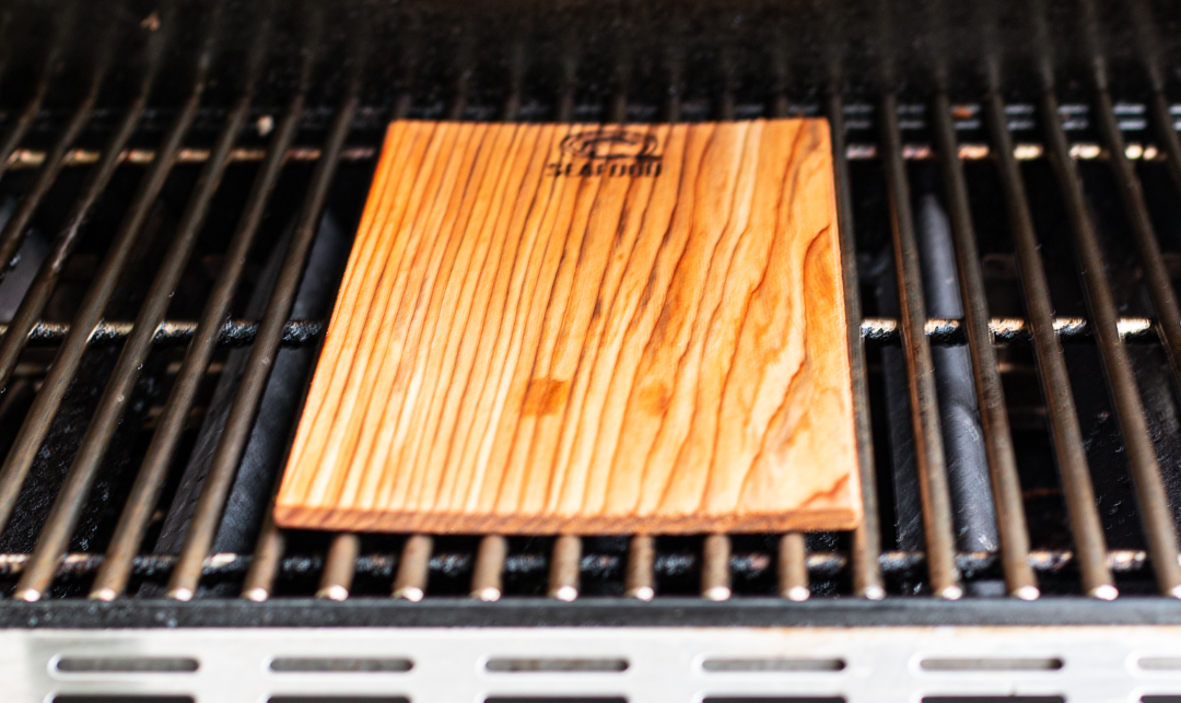 Place soaked cedar plank on grill, close and turn over in a few minutes when it has blackened a bit 