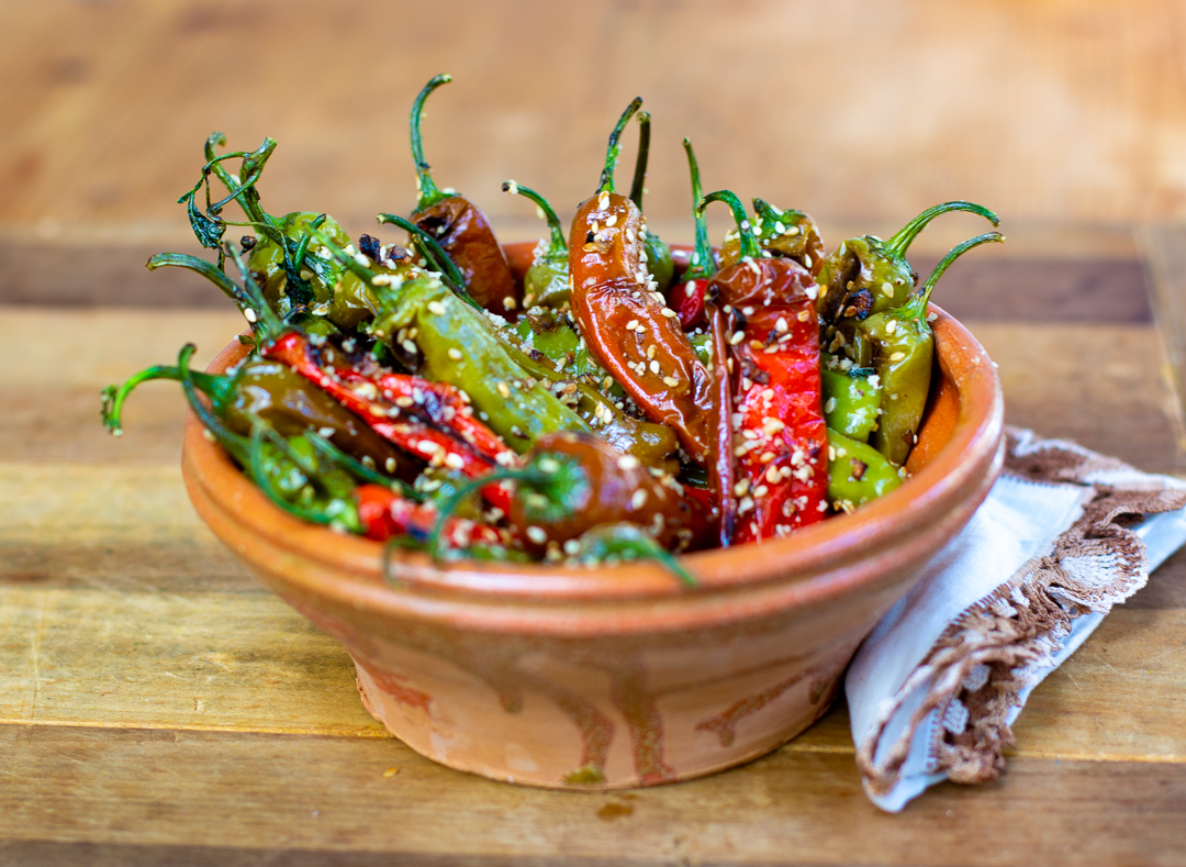 Peppers with Sesame Seeds, Shallots and Hazelnuts in French Clay bowl 