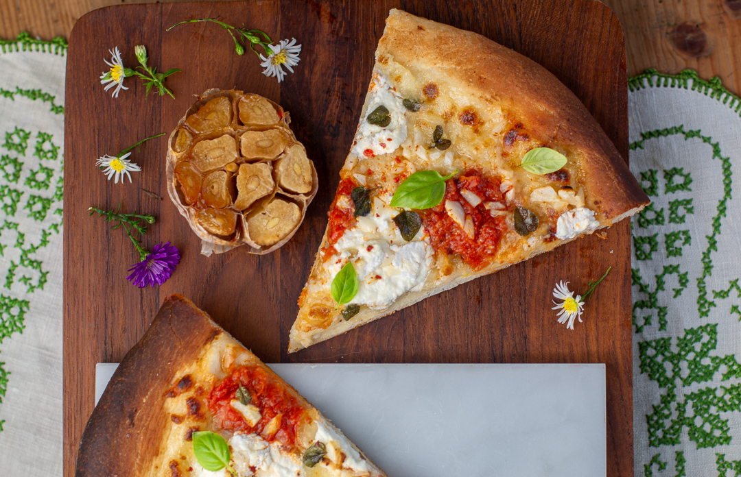 Garlic Pizza - Roasted Garlic Halves are mashed and spread on the dough 