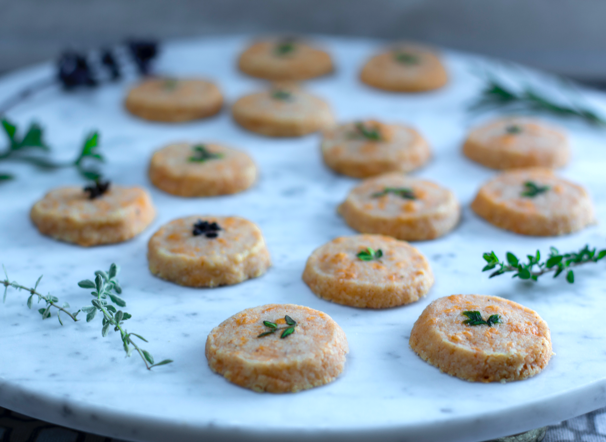 Cheddar and Herb “Pennies” ~ Savory Shortbread Crackers on a marble platter