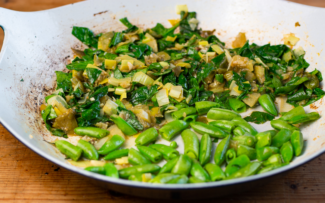 Fresh spinach and sautéed with sugar snap peas are added 