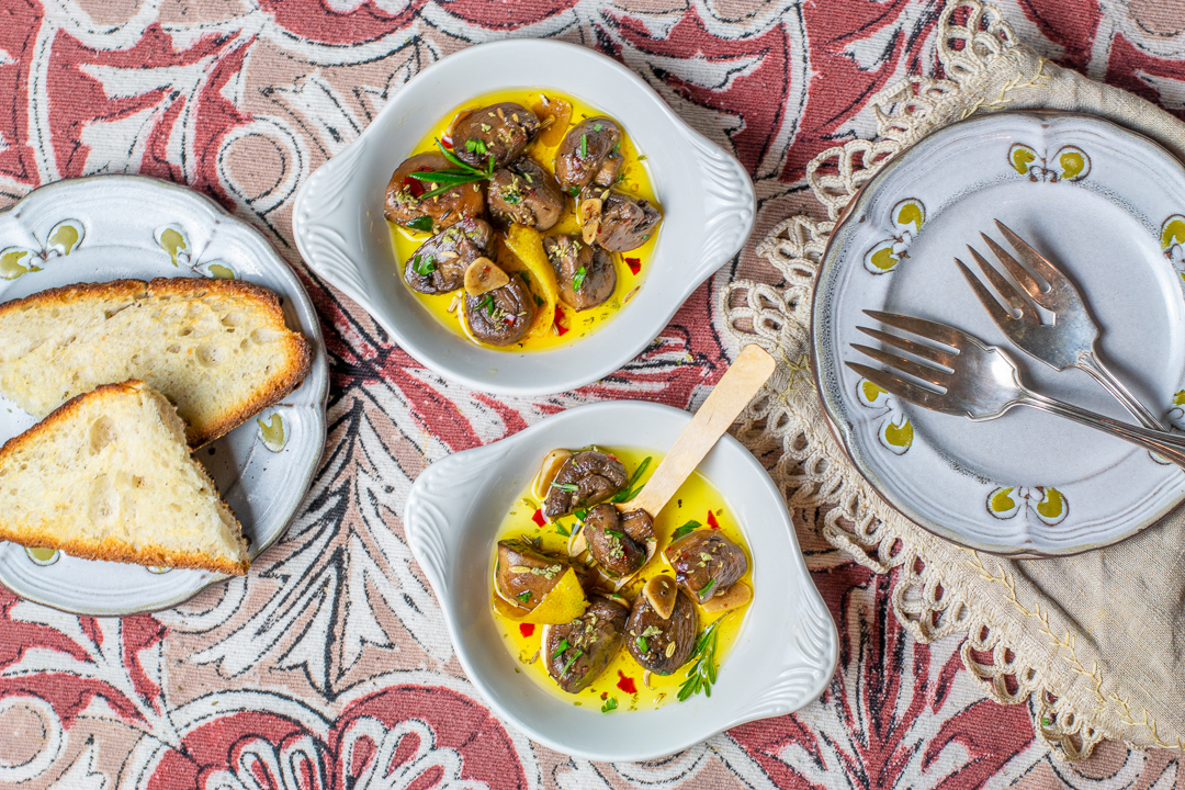 Serving the Tuscan Marinated Mushrooms in Individual shallow bowls with Toasted bread to soak up all the juices 