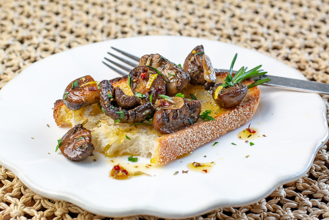 Top your favorite toasted bread with this tangy- herbal Tuscan Marinated Mushrooms! 