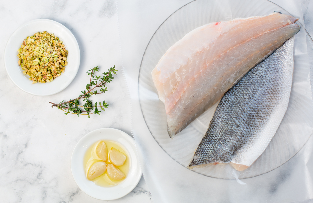 Branzino Fillets to the coated with mashed garlic and topped with chopped pistachios 