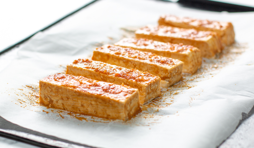 Brush Tofu with the Ginger-Sesame Sauce - then roast in a 400 degree oven until golden - delish!