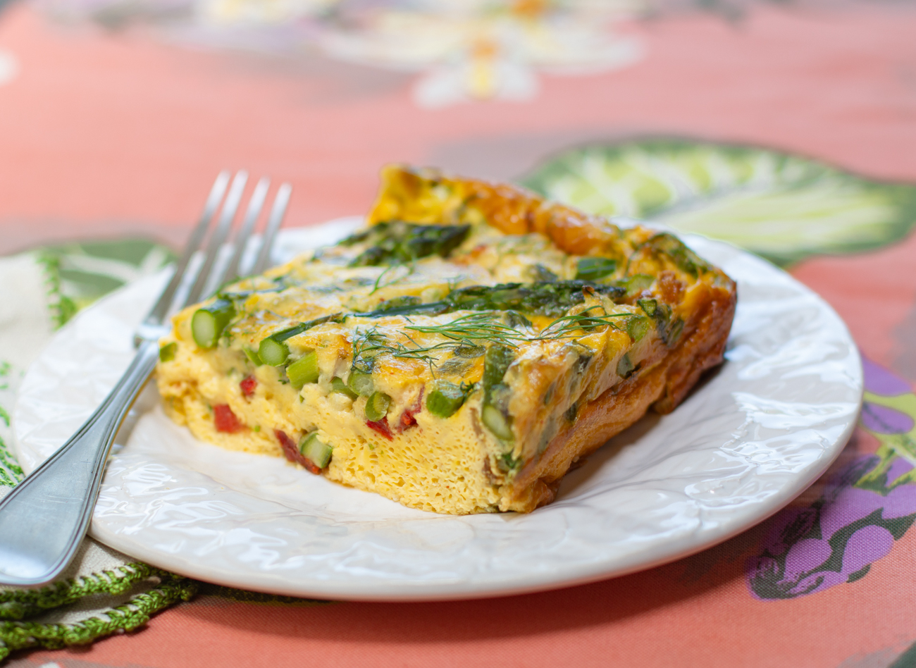 A serving of Asparagus Frittata with Roasted Peppers & Dill