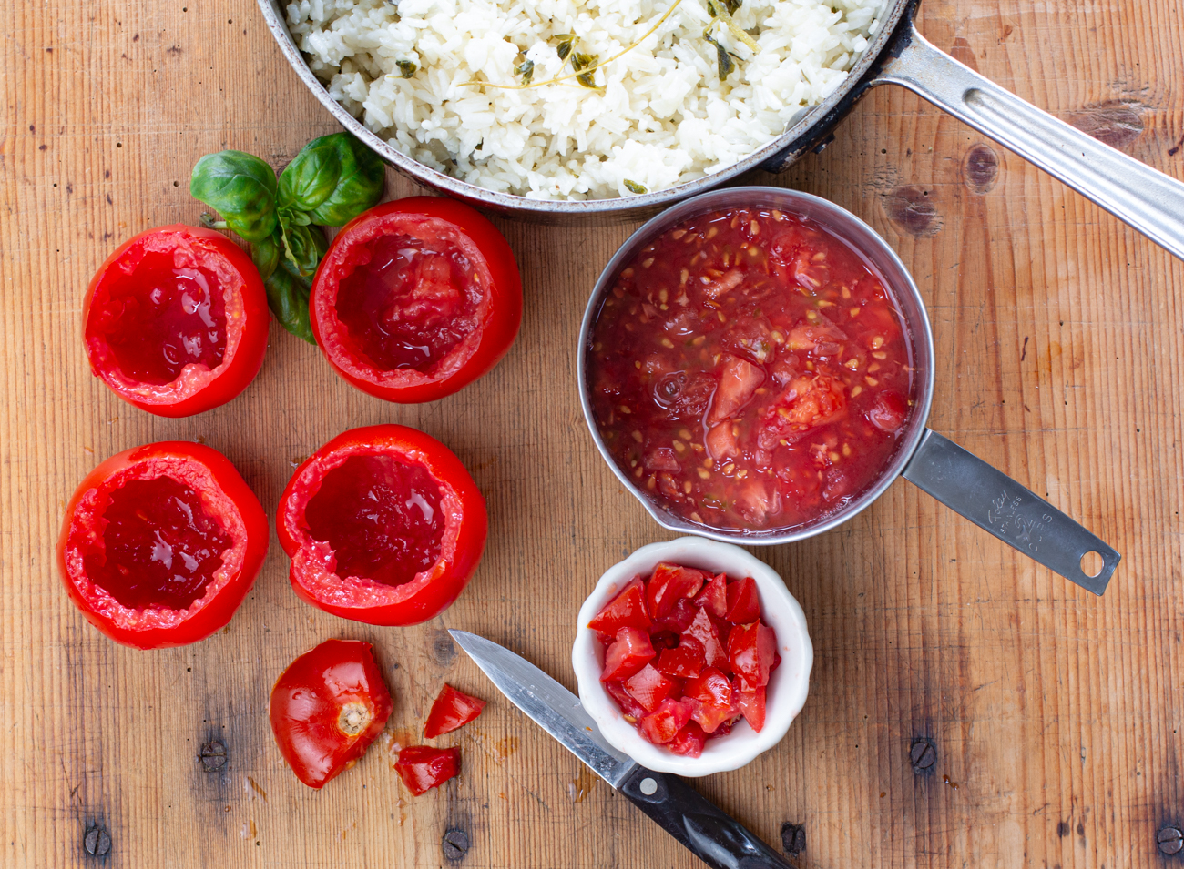 Puttanesca Rice Stuffed Tomatoes: Hallow our tomatoes - save tops for dicing 