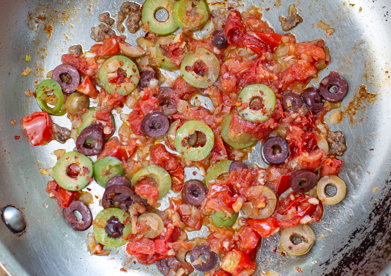 Sauté onions, garlic, chopped tomatoes, and olives ~ then fold in the cooled rice 