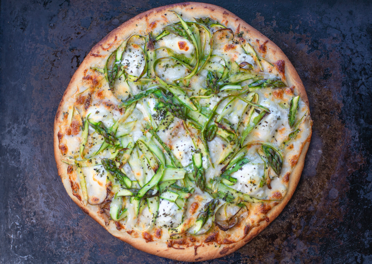Crispy perfectly cooked Shaved Asparagus White Pizza - ready to cut and enjoy