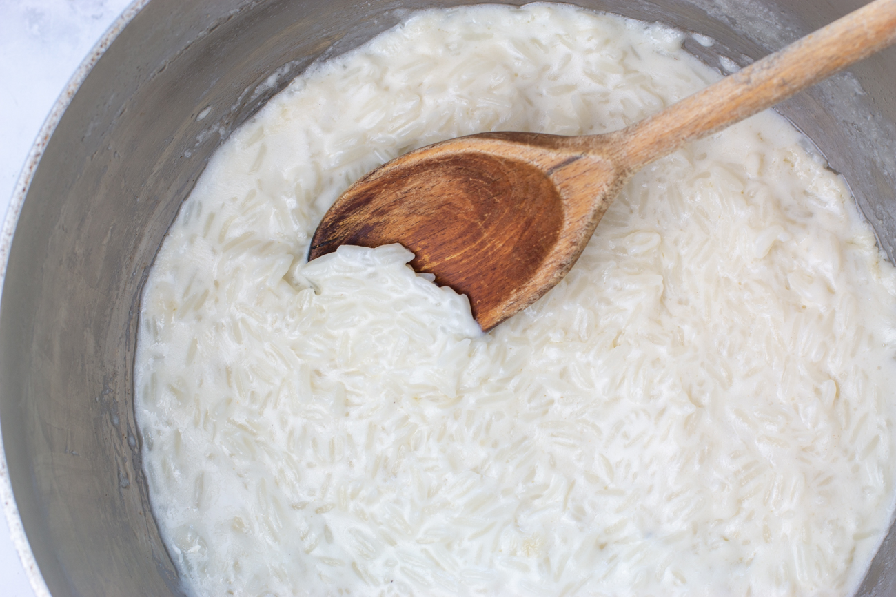 Cooking the rice in coconut milk & milk for the custard rice pudding 