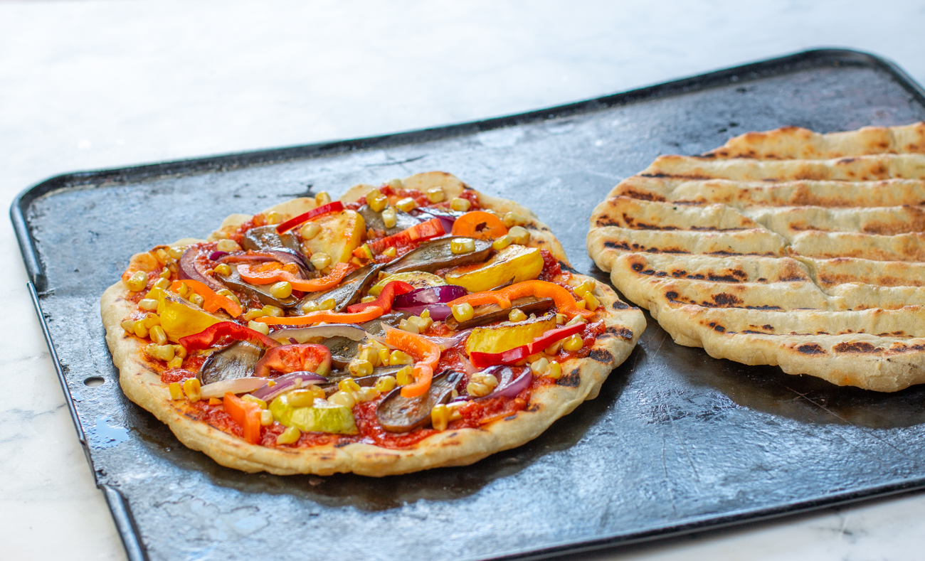 The pizza dough is grilled; flip over (grill marks up) add sauce and layer with veggies 