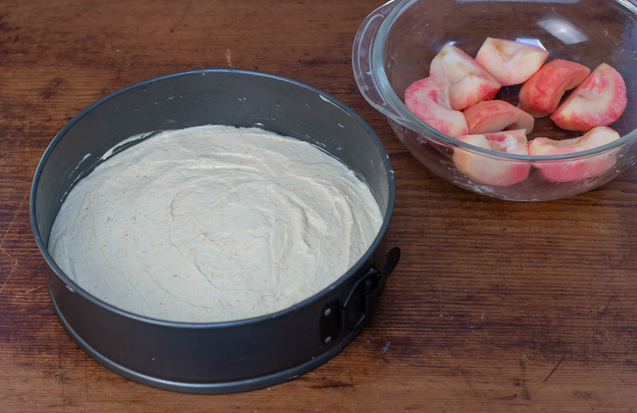 German Pink Pearl Apple Cake; Make the cake batter, add to you springform pan, top with scored apple slices 