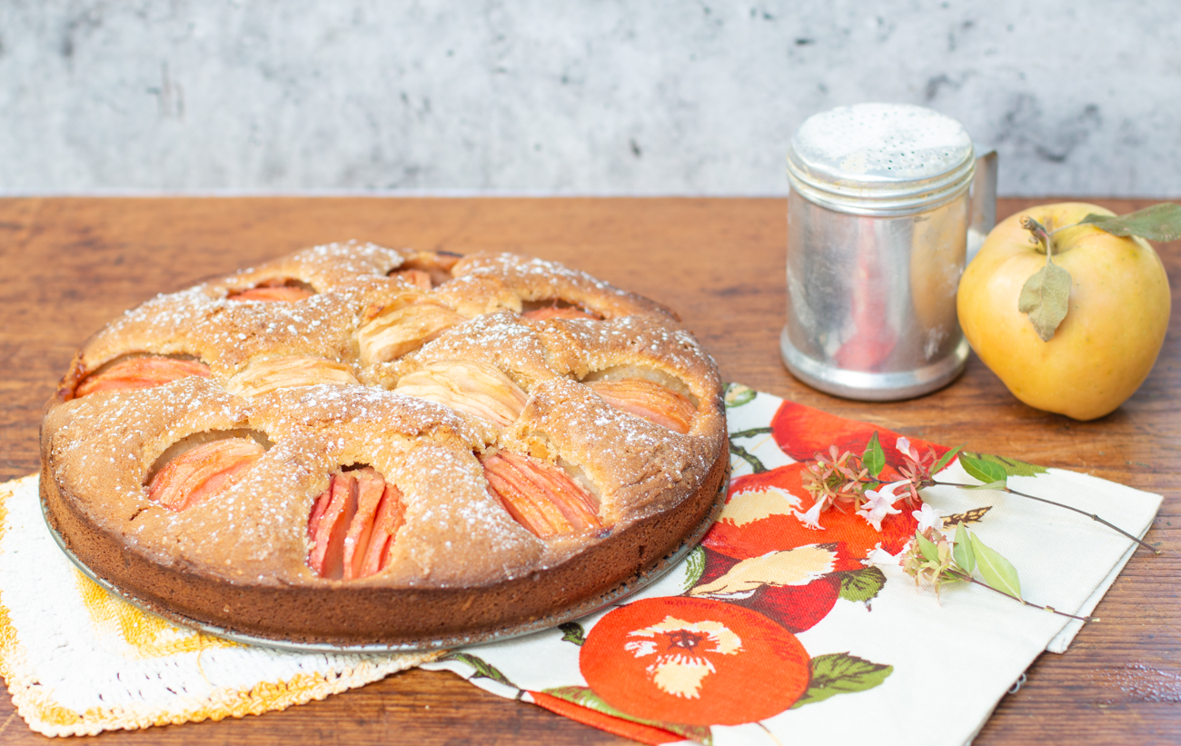 German Apple Cake out of the oven - dusted with confectioner's sugar