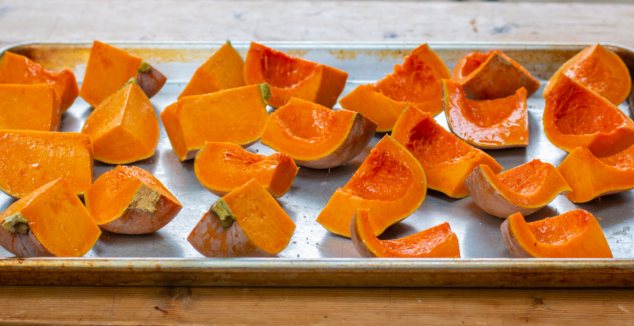 Cut Honeynut squash ready to roast in a hot oven 