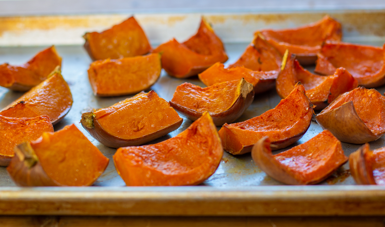 Honeynut squash out of the oven, slightly golden edges, creamy and cooked flesh 