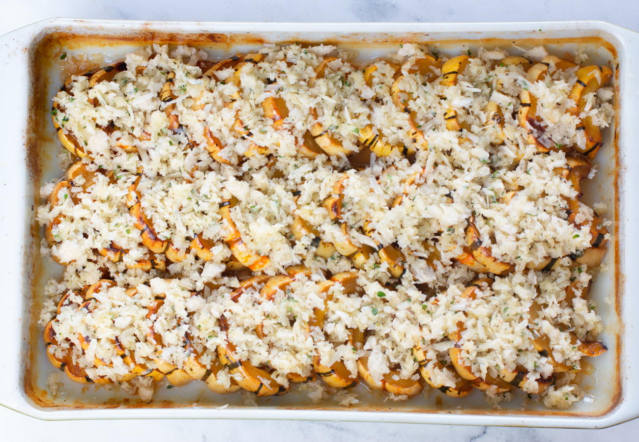 Cooked Delicata Squash topped with Parmesan Breadcrumbs - ready to bake 