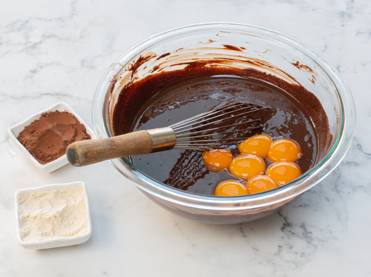 Add egg yolks to chocolate and butter mixture 