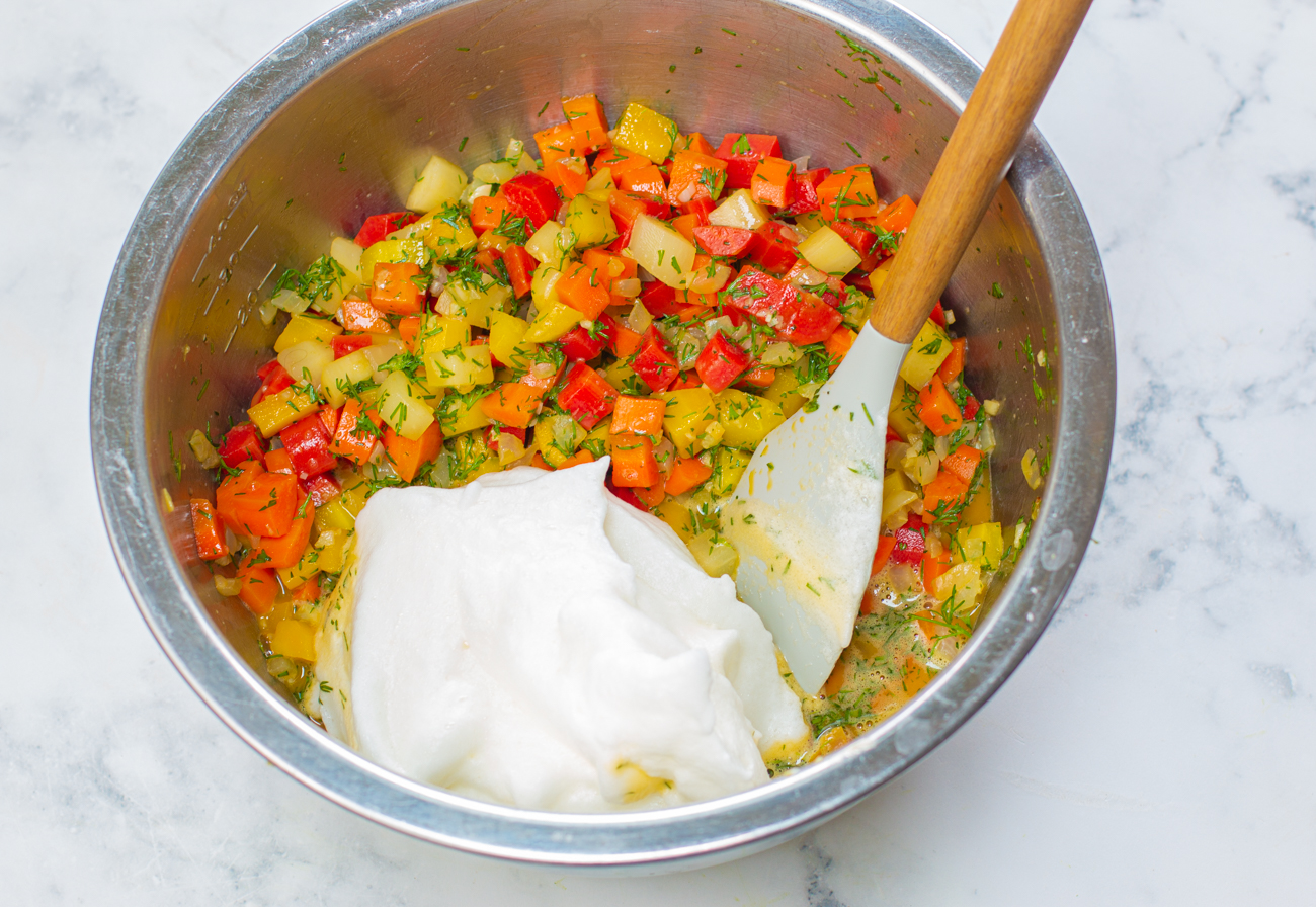 Adding the whipped egg whites ti the carrot mixture 