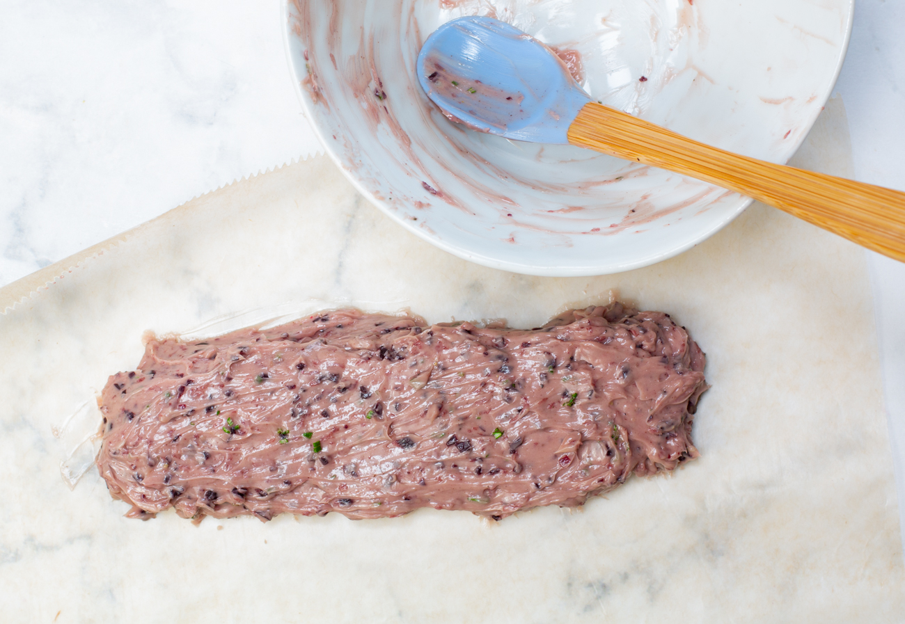 Add the mixed compound butter to a sheet of waxed paper, and roll into a tight cylinder 